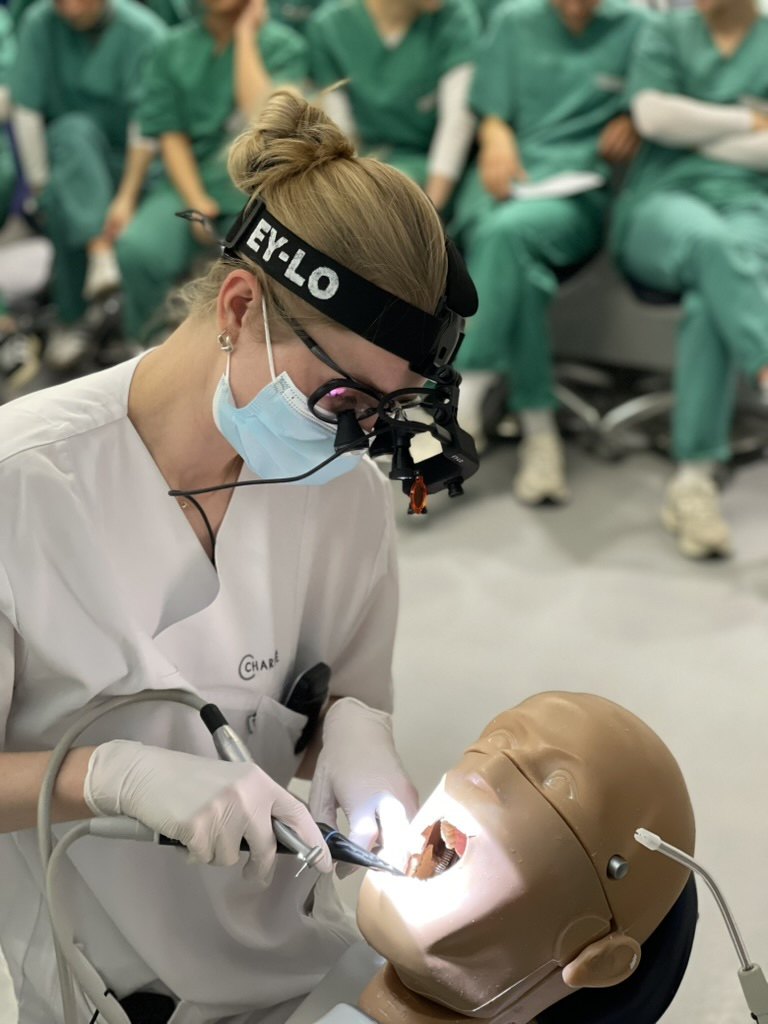 EY-LO on the head strap, next to the loupes, in a university phantom head course